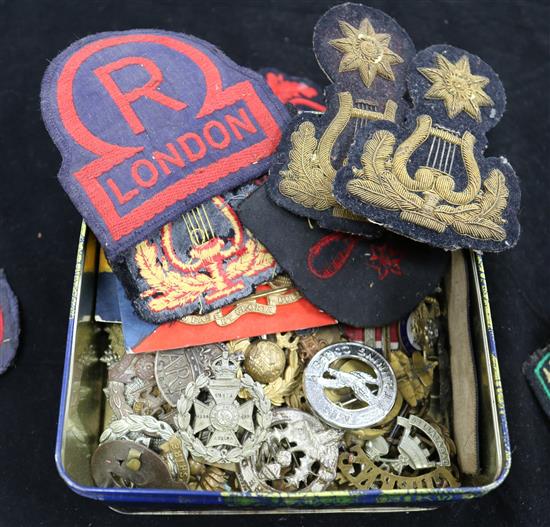 A collection of military cap and uniform badges